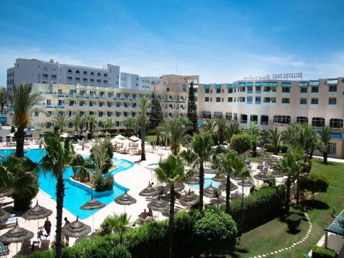 an aerial view of a resort with a pool and palm trees at Sentido Bellevue Park in Port El Kantaoui