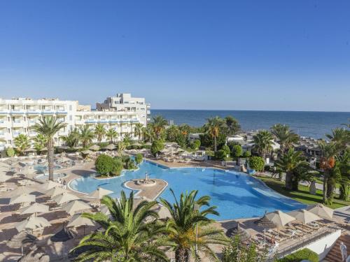 an aerial view of a resort with a swimming pool and the ocean at Sentido Bellevue Park in Port El Kantaoui