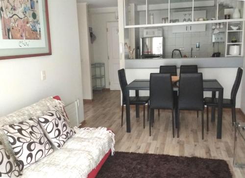 a living room with a dining room table and chairs at Bosque Nevado in Nevados de Chillan