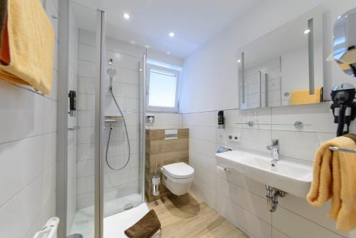 a bathroom with a shower and a toilet and a sink at Ginsberger Heide in Hilchenbach