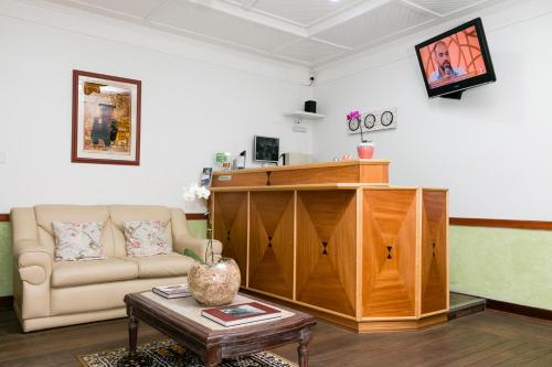 a living room with a couch and a table at Hotel Residenza - 400m do inicio da Av Paulista e Metrô Paraiso in Sao Paulo