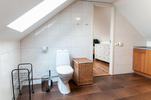 a bathroom with a toilet and a sink at Cozy Apartment in Uppsala