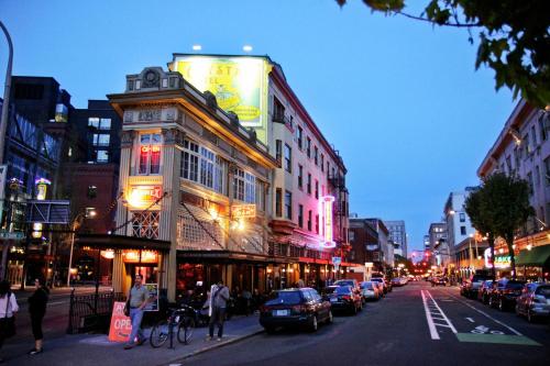 a city street with cars parked on the side of a building at McMenamins Crystal Hotel in Portland