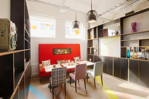 a dining room with a red table and chairs at Reykjavik Marina - Berjaya Iceland Hotels in Reykjavík