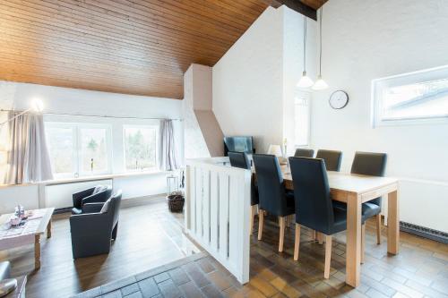 a dining room with a table and chairs at Ferienhaus Eifelurlaub in Biersdorf