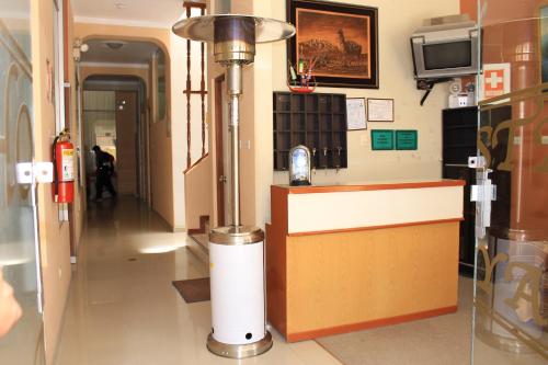 a lobby of a store with a cash counter and aperature at Maya Inn in Puno