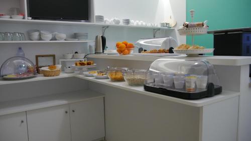 a kitchen with a counter with food on it at Domus Nova in Reggio Calabria