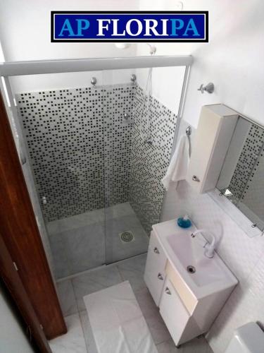 a bathroom with a shower and a sink and a toilet at AP Floripa in Florianópolis