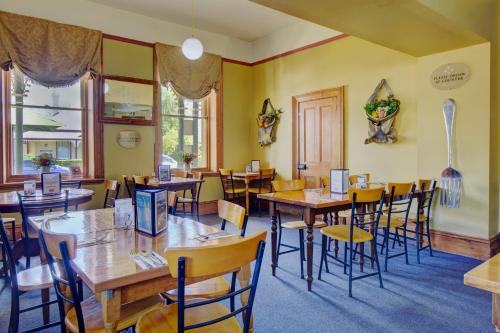 a dining room with wooden tables and chairs at The Richmond Arms Hotel in Richmond