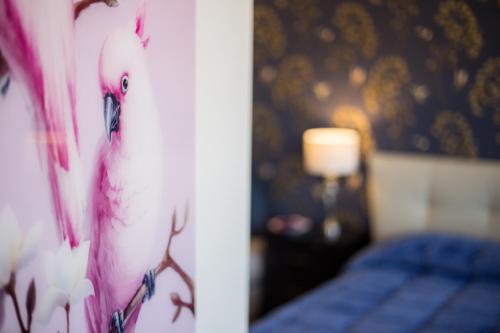a bedroom with a bed with a bird painted on the wall at B & B La Terrazza sul mare in Portoferraio