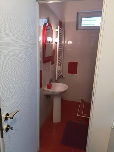 a bathroom with a white sink and a mirror at Casa Rezidentiala Aria in Cluj-Napoca