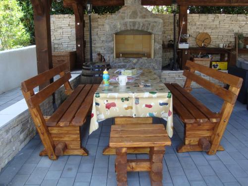 a table and chairs with a table and a fireplace at Villa Flora in Malinska