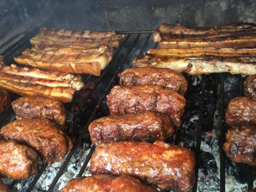 a bunch of different types of food on a grill at Country house Egomer in Călugări