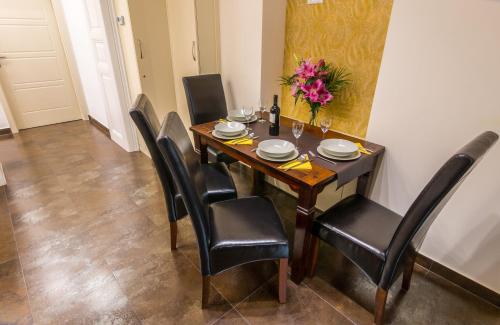 a dining room table with black chairs and flowers on it at Dob Twenty Rooms in Budapest