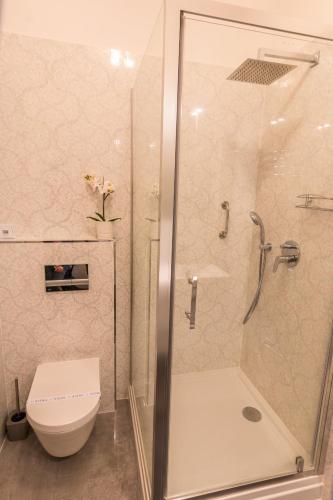 a bathroom with a shower and a toilet at Dob Twenty Rooms in Budapest
