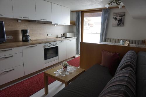 ein Wohnzimmer mit einem Sofa und einem Tisch in der Unterkunft Ferienwohnungen Durst Roswitha in Schattwald