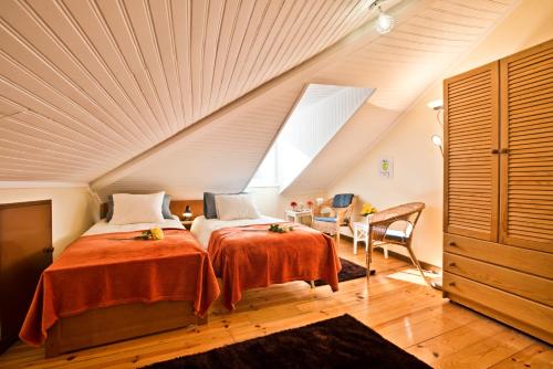a attic bedroom with two beds and a window at Old Town Loft in Lisbon