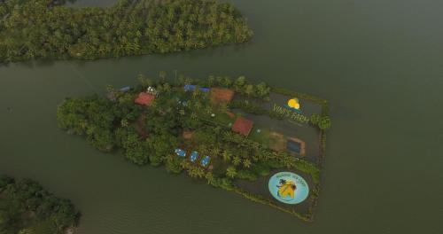 an island in the water with a house on it at Munroe Eco Camp in Munroe Island