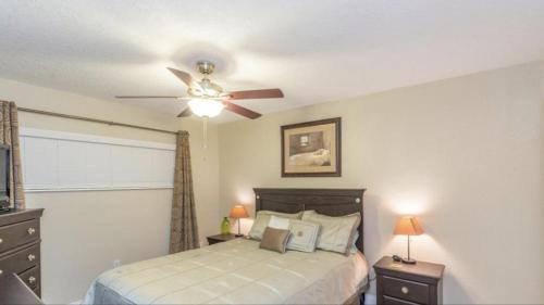 a bedroom with a bed and a ceiling fan at Tropical Paradise at Diplomat in Cocoa Beach