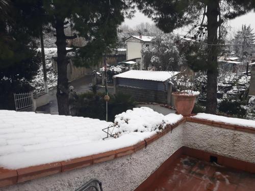 a snow covered roof of a house with a yard at SOGNO Vacanze in Massa