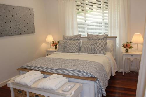 a bedroom with a bed with two towels on it at Pirralilla Estate Adelaide Hills in Aldgate