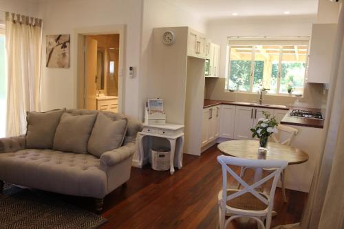 a living room with a couch and a table at Pirralilla Estate Adelaide Hills in Aldgate