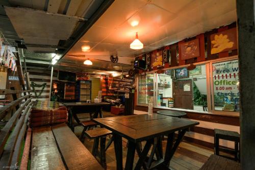 a restaurant with tables and chairs in a room at Tuk Tuk Guesthouse in Ko Chang