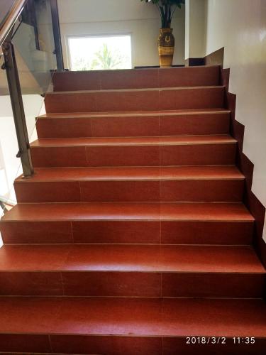 a stairway with brown steps with a vase on it at Bicotels Hotel in Batangas City