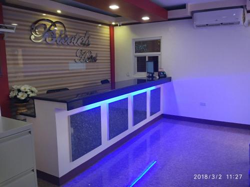 a swimming pool in a room with purple lighting at Bicotels Hotel in Batangas City