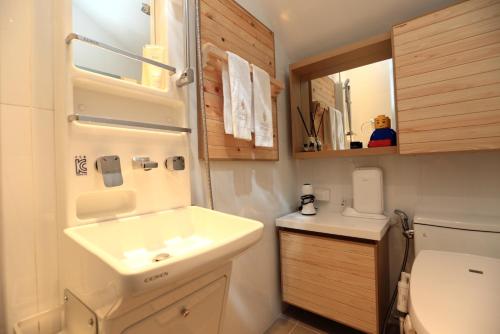 a small bathroom with a sink and a toilet at Farms Village in Jeju