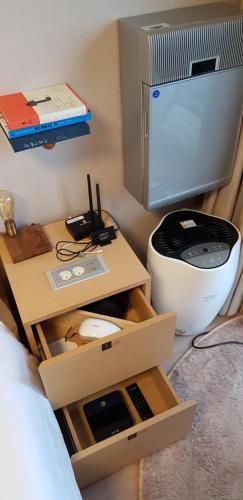 a room with a bed and a tv on a table at Farms Village in Jeju