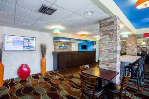 a waiting room with a table and chairs and a counter at Days Inn by Wyndham Sarasota Bay in Sarasota