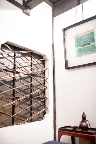 a wall mount wine rack in a room with a table at KYOTO Kazenoya Sara in Kyoto
