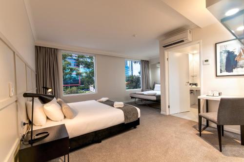 Ένα ή περισσότερα κρεβάτια σε δωμάτιο στο Woodroffe Hotel