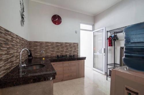 a kitchen with a sink and a counter top at Kuta Regency B10 One Bedroom Villa in Kuta