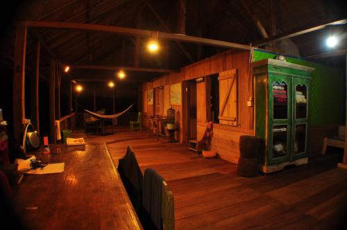 a room with a long wooden table in a building at 4 Pohon - Les 4 Arbres in Pandang