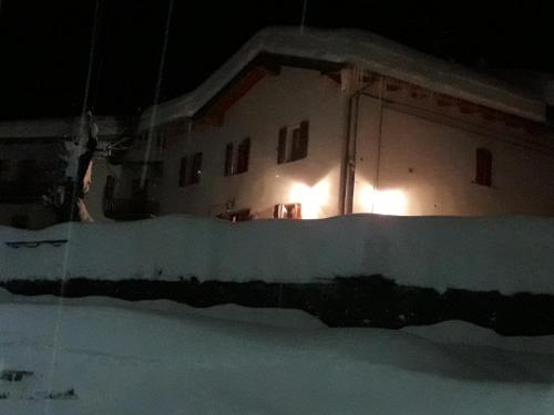 a house with lights on the side of it at night at B&B La Tana Dei Ricci in Sestola