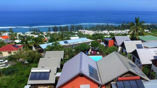 an aerial view of a town with houses and the ocean at Le Cardinal des Grands Bleus in Saint-Leu