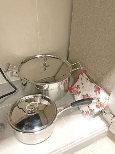 a pot and a pan sitting on top of a counter at Seaview Apartment in Kuah