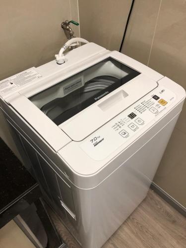 a white toaster oven sitting on top of a counter at Seaview Apartment in Kuah