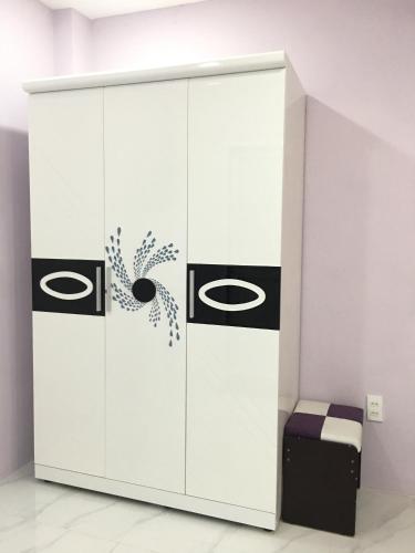 a white wardrobe with black and white graphics on it at HT Hotel Apartment in Ho Chi Minh City