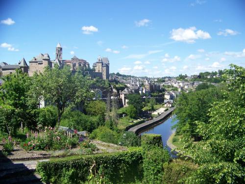 a view of a city with a river at Logis Hôtel Teyssier in Uzerche