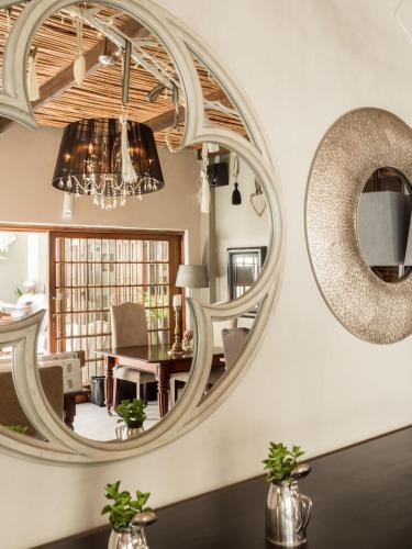 a large mirror on the wall in a living room at Lairds Lodge Country Estate in Plettenberg Bay