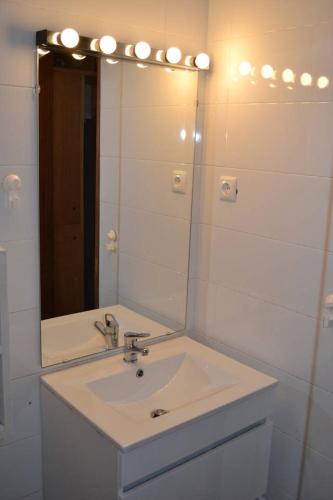 a bathroom with a sink and a mirror at Studio M in Mindelo