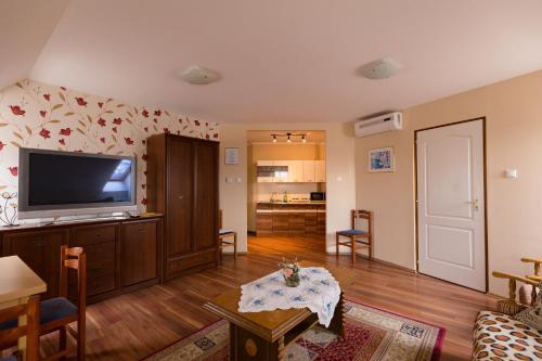 a living room with a flat screen tv on a wall at Alíz Vendégház in Békéscsaba