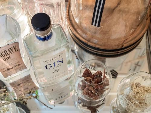 a bottle of gin sitting on top of a table at Lairds Lodge Country Estate in Plettenberg Bay