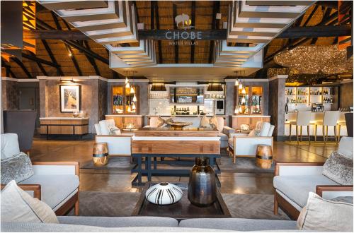a lobby with couches and tables in a store at Chobe Water Villas in Kasika