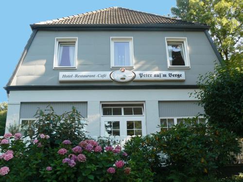 a blue house with a sign on the side of it at Waldhotel "Peter aufm Berge" in Bielefeld
