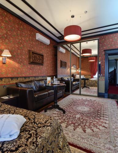 a hotel room with a bed and a couch at La Gioconda Boutique Hotel in Odesa