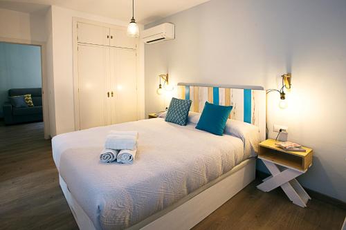 una camera da letto con un letto e due asciugamani di HI Suite Málaga Centro a Málaga